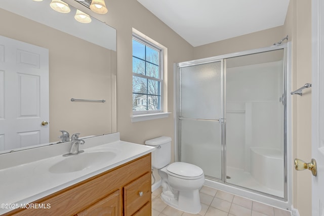 bathroom with tile patterned flooring, a shower stall, toilet, and vanity