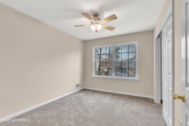 unfurnished bedroom featuring baseboards, visible vents, ceiling fan, carpet flooring, and a closet