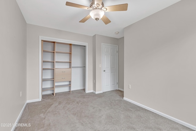 unfurnished bedroom featuring a closet, carpet flooring, a ceiling fan, and baseboards