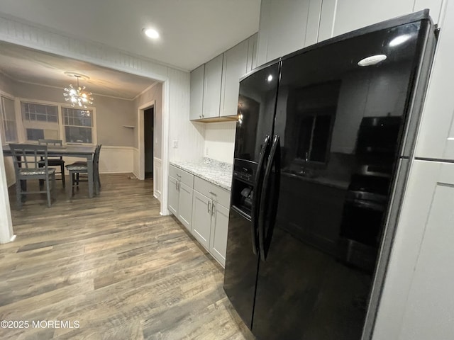 123 Harbor Inn Rd, Bayville, NJ 08721 - kitchen featuring black fridge, light wood finished floors, a chandelier, light stone countertops, and crown molding