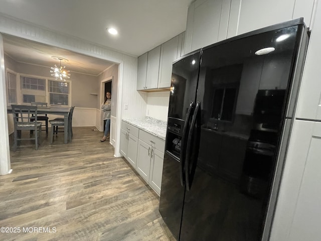 123 Harbor Inn Rd, Bayville, NJ 08721 - kitchen with black refrigerator with ice dispenser, light wood-style floors, a chandelier, recessed lighting, and a wainscoted wall