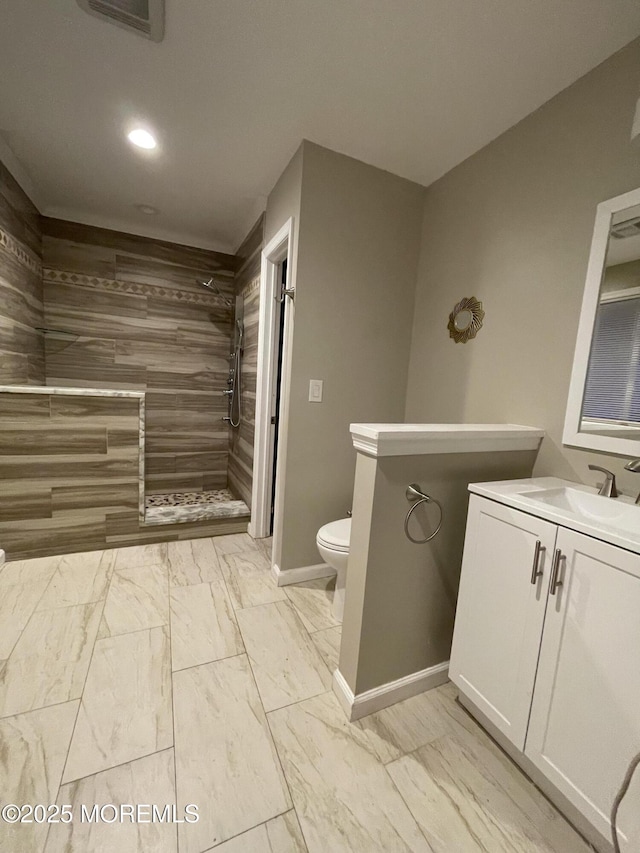 123 Harbor Inn Rd, Bayville, NJ 08721 - bathroom featuring marble finish floors, a tile shower, toilet, vanity, and recessed lighting