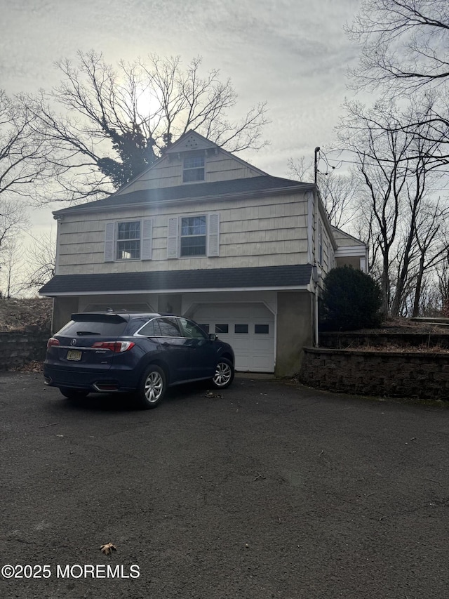 view of home's exterior featuring driveway and a garage