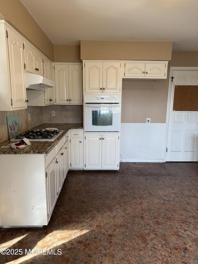 kitchen with white cabinets, stainless steel gas stovetop, oven, and under cabinet range hood