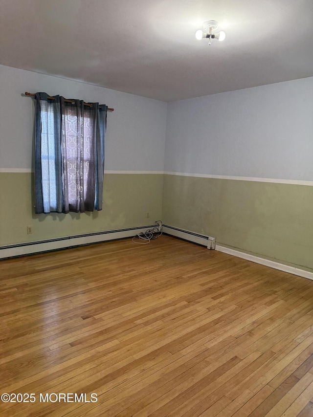 unfurnished room with hardwood / wood-style floors