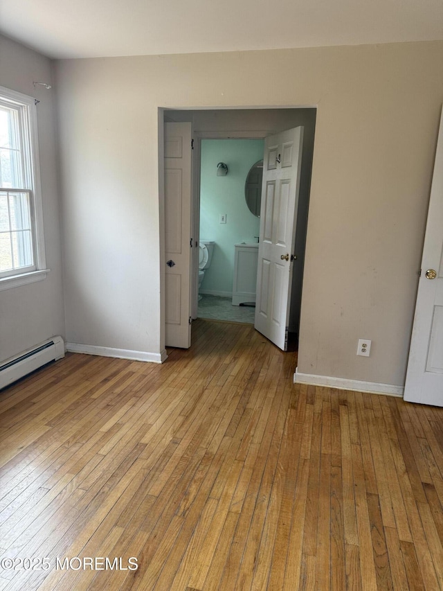 unfurnished bedroom featuring light wood-style floors and baseboards