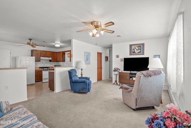 living area with ceiling fan, a baseboard radiator, visible vents, and light colored carpet