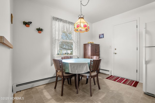 dining space with a baseboard heating unit