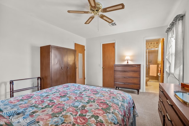 bedroom featuring light carpet, visible vents, a ceiling fan, ensuite bathroom, and a closet