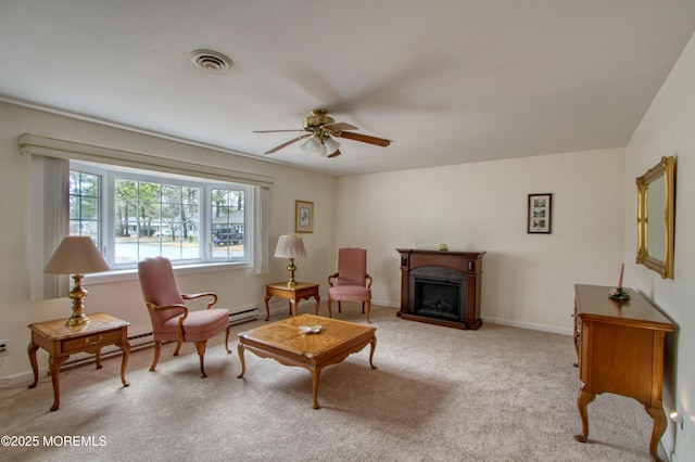 sitting room with carpet, a fireplace, visible vents, ceiling fan, and baseboards