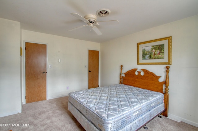 carpeted bedroom with a ceiling fan, visible vents, and baseboards