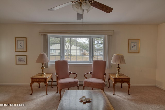 living area featuring a ceiling fan, carpet, baseboard heating, and baseboards