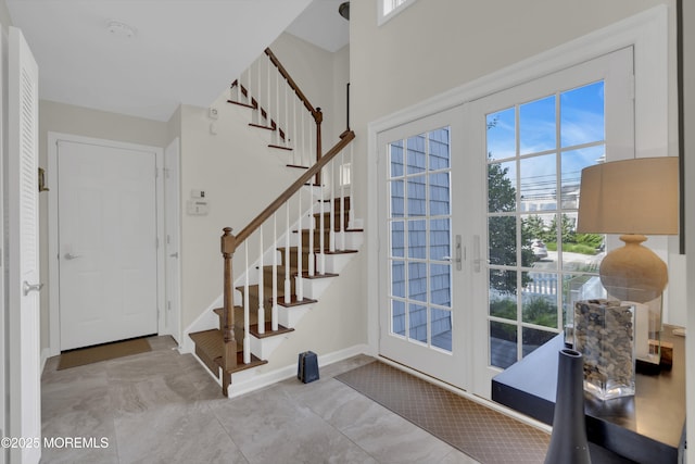 entryway with stairs, french doors, and baseboards