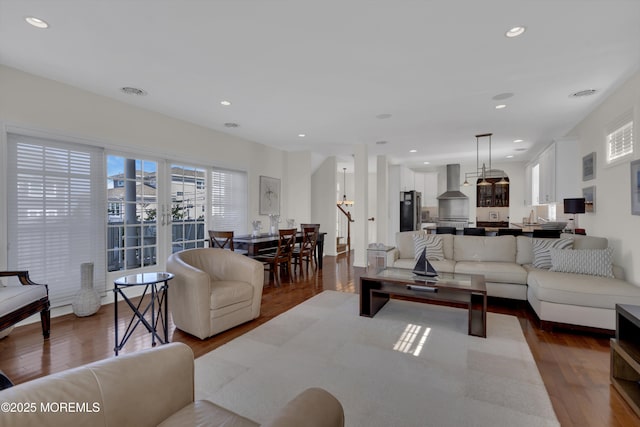 living room featuring visible vents, dark wood-style flooring, and recessed lighting