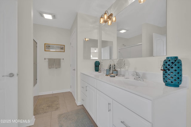 full bath featuring double vanity, visible vents, tile patterned flooring, an enclosed shower, and a sink