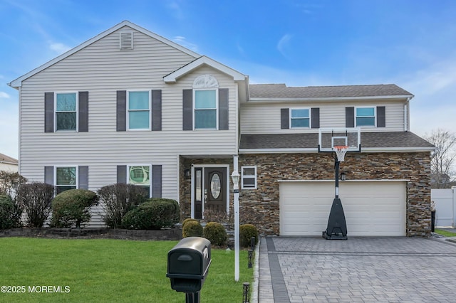 view of front of property featuring a garage, stone siding, a front lawn, and decorative driveway