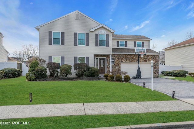 view of front of house with a front yard, fence, a garage, stone siding, and driveway