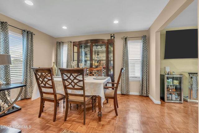 dining area with recessed lighting, beverage cooler, and baseboards