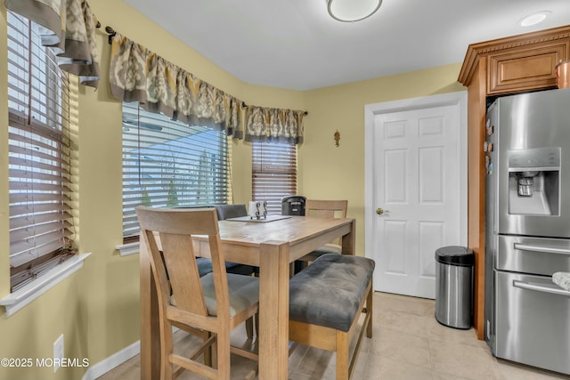 dining room with a healthy amount of sunlight and light tile patterned floors