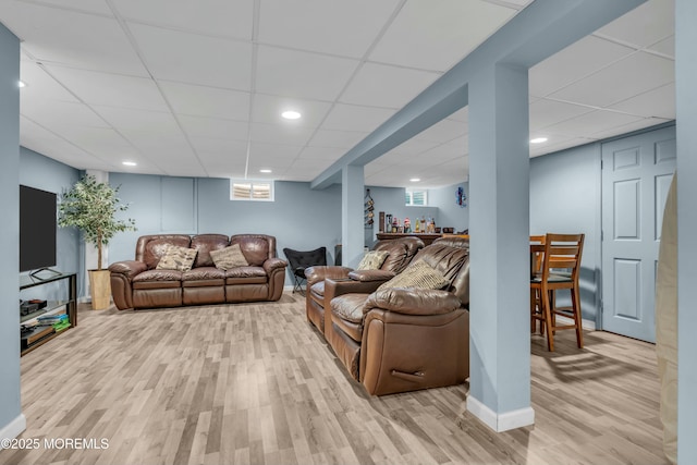 living area featuring light wood-type flooring, a paneled ceiling, and recessed lighting