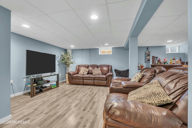 living room with a paneled ceiling, baseboards, wood finished floors, and recessed lighting