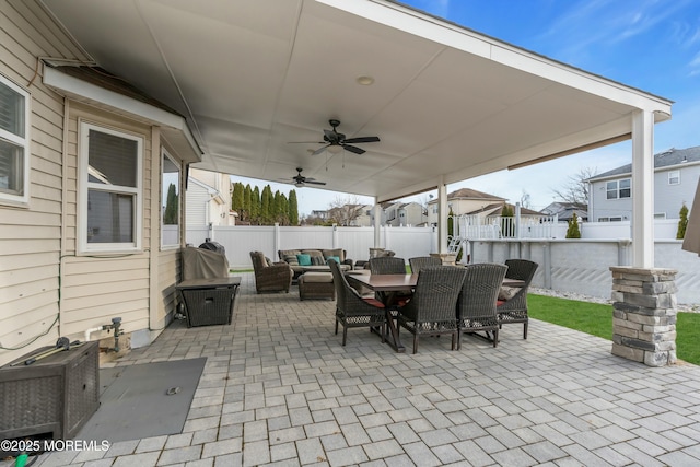 view of patio with outdoor dining area, ceiling fan, outdoor lounge area, and a fenced backyard