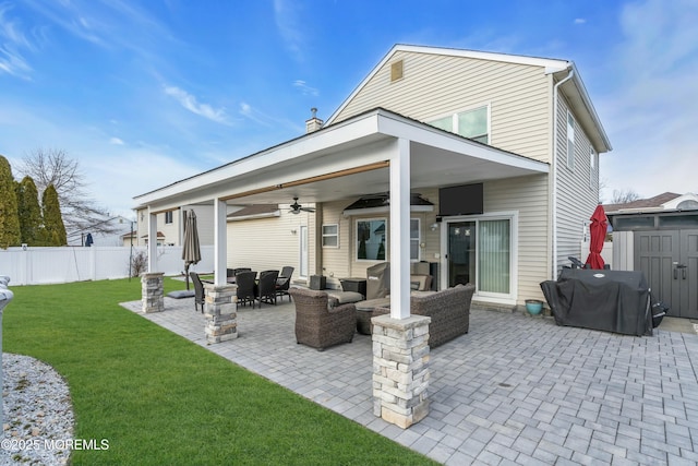 back of house with an outdoor hangout area, fence, a ceiling fan, a yard, and a patio area