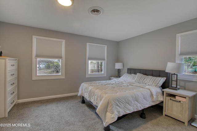 bedroom featuring light colored carpet, visible vents, and baseboards