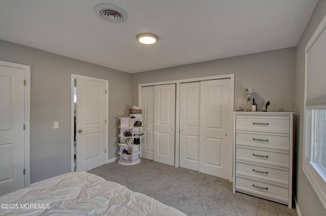 carpeted bedroom with baseboards and visible vents