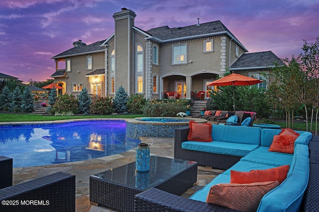 view of pool with a patio area, a pool with connected hot tub, and outdoor lounge area