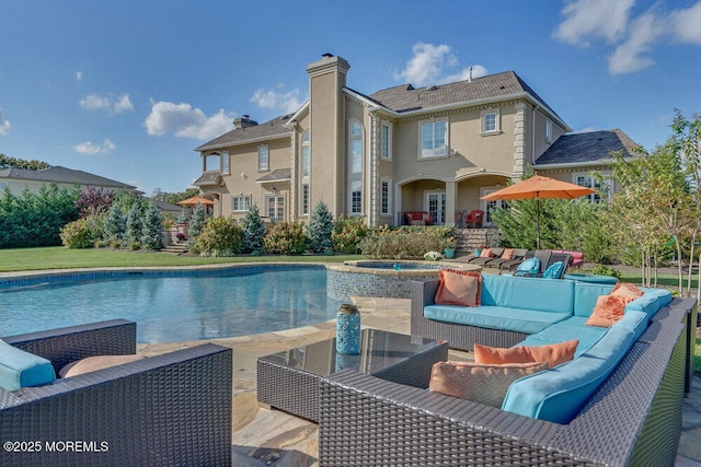 view of swimming pool with an outdoor hangout area, a pool with connected hot tub, and a patio