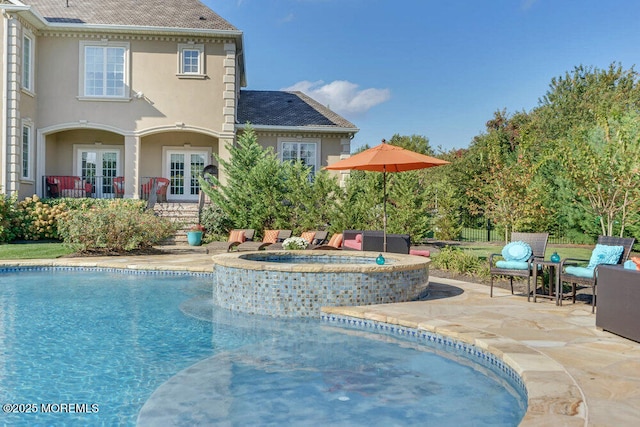 view of swimming pool with french doors, a patio, a fenced in pool, and an in ground hot tub