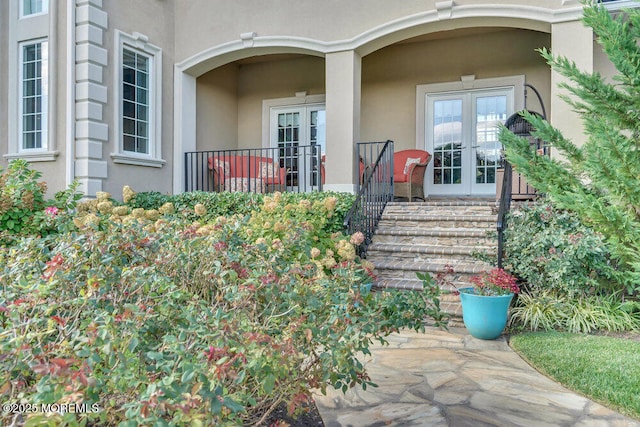 property entrance with french doors and stucco siding