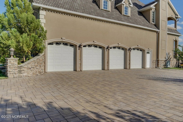 garage featuring decorative driveway