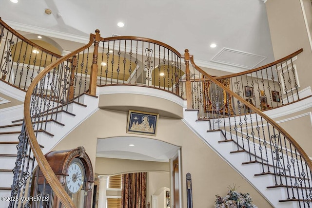 stairs featuring a high ceiling, recessed lighting, and ornamental molding