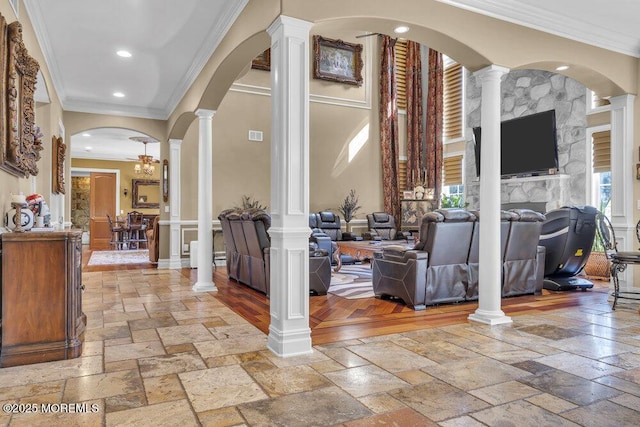 entrance foyer featuring stone tile floors, decorative columns, and ornamental molding