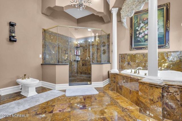 bathroom featuring decorative columns, a bidet, and a shower stall