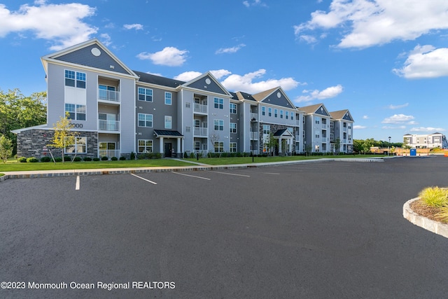 view of property featuring uncovered parking