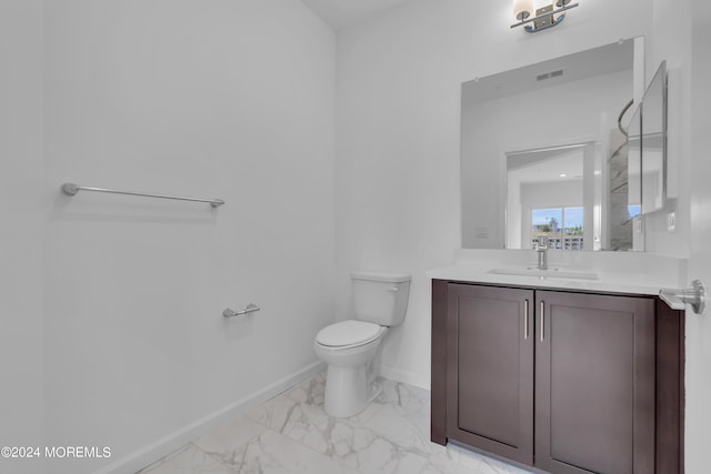 half bathroom featuring visible vents, baseboards, toilet, marble finish floor, and vanity