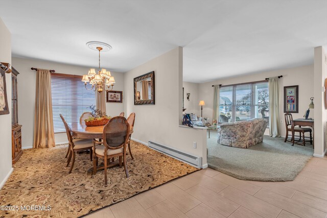 dining room featuring baseboards, baseboard heating, and a notable chandelier