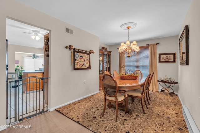 dining area featuring baseboards, ceiling fan with notable chandelier, visible vents, and light tile patterned flooring