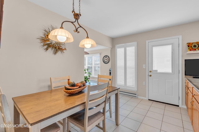 dining space with a baseboard radiator, light tile patterned flooring, and baseboards