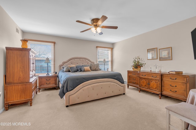 bedroom featuring light colored carpet, ceiling fan, and visible vents