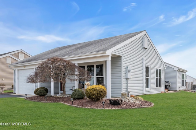 view of side of property featuring a garage, a shingled roof, central AC unit, a lawn, and aphalt driveway