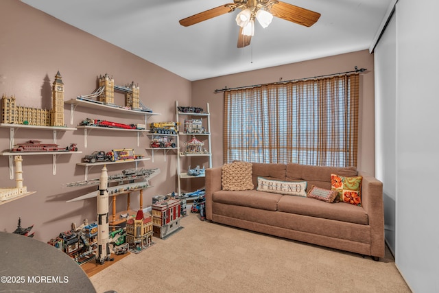 interior space with a ceiling fan and carpet flooring