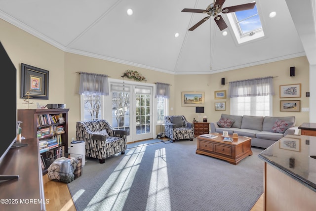 living area with ceiling fan, high vaulted ceiling, recessed lighting, a skylight, and ornamental molding