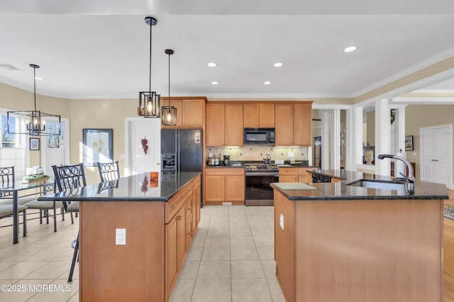 kitchen with a kitchen island with sink, a sink, black appliances, and light tile patterned flooring