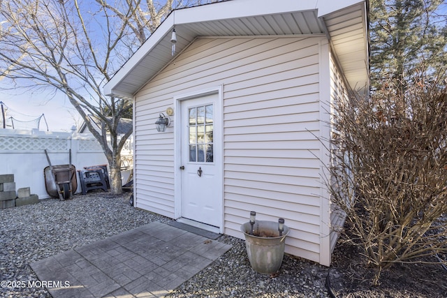 exterior space with fence and an outbuilding