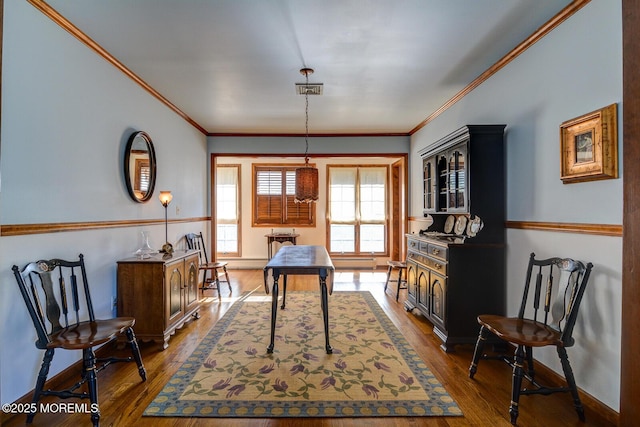 office space featuring dark wood-style floors, crown molding, and baseboards