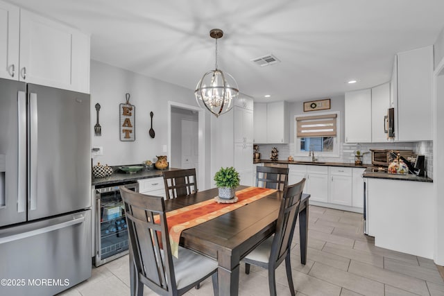 dining room with wine cooler, visible vents, recessed lighting, and an inviting chandelier